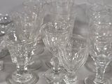 a lot of glasses that are sitting on a table