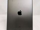 the back of an ipad with a black apple logo on it