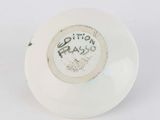 a white bowl with writing on it sitting on a table