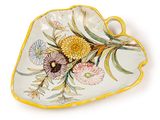 an image of a yellow and white plate with flowers on it