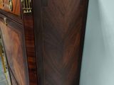 a wooden cabinet that has a marble top on it