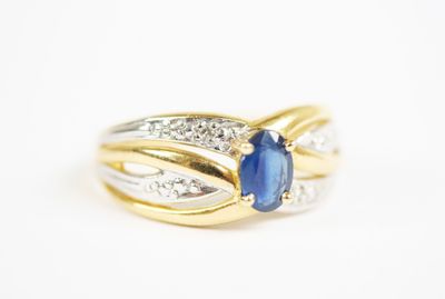 a yellow gold ring with a blue sapphire and diamonds