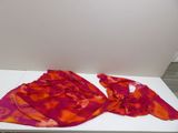 a red and orange scarf on a white table