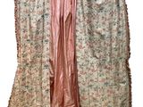 an image of a dress hanging on a hanger on a white background