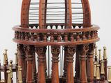 a wooden structure with a birdcage on top of it