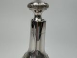 a silver vase that is sitting on a table