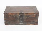 an old wooden box sitting on top of a white surface