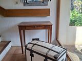 a white suitcase sitting on the floor in front of a window