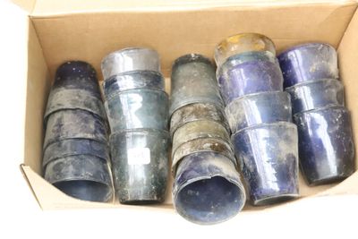 a cardboard box with a bunch of blue glass bottles in it