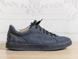 navy blue sued sneakers with laces on a wooden table