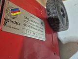 a close up of a red machine with a label on it