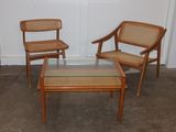 three chairs and a coffee table in a room