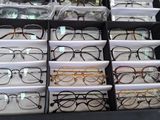 many pairs of glasses in a box on a table