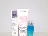 two bottles of lancomine and a tube of toothpaste on a table