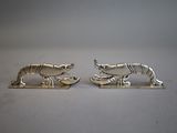 pair of silver plated animal cufflinks on a white surface