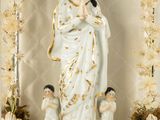 a statue of the virgin mary surrounded by her children