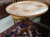 a small table with a wooden top in a room