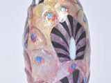 a vase with a design on it on a white surface