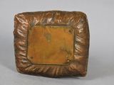a bronze picture frame with a gold plate in the middle