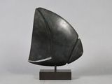 a bronze sculpture of a sailboat on a wooden base