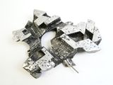 a piece of metal that has been made into a brooch