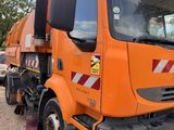 a large orange truck that is parked in a lot