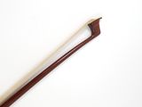 a close up of a wooden stick on a white surface