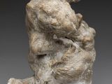 a close up of a sculpture of a bear on a rock