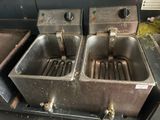 two stainless steel sinks sitting next to each other in a kitchen