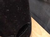 a close up of a pair of black shoes on a wooden table