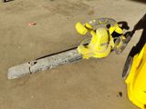 a chainsaw that is laying on the ground next to a yellow bucket