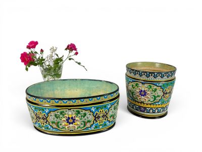two vases sitting next to each other with flowers in them