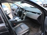 the interior of a car with the door open and the driver ' s seat down