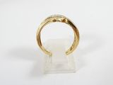 a close up of a gold ring on a clear stand