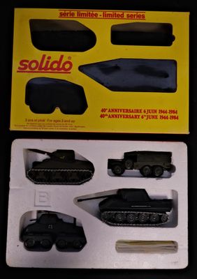 a box with a toy army vehicle and other items in it