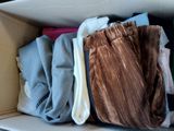a box full of clothes that is sitting on a shelf