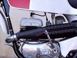 a red and white motorcycle parked in front of a building