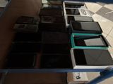many cell phones sitting on a table in a room