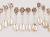 six pairs of silver spoons and a pair of silver spoons