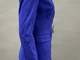 female mannequin wearing a blue jacket and black leggings