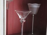 a wine glass sitting on top of a shelf in a cabinet