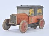 an old fashioned toy car with wheels on a white surface