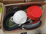 a box full of kitchen utensils sitting on the floor