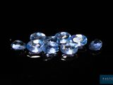 some very pretty blue diamonds on a black surface