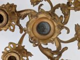 a gold colored chandelier with a blue eye in the center