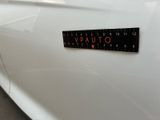 a close up of a sticker on the side of a white car