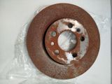 a rusted disc on a plastic bag on a table