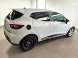 the rear end of a white car parked in a garage