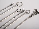 six wrenches are lined up in a row on a white surface