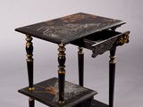 a black and gold table with a drawer on it